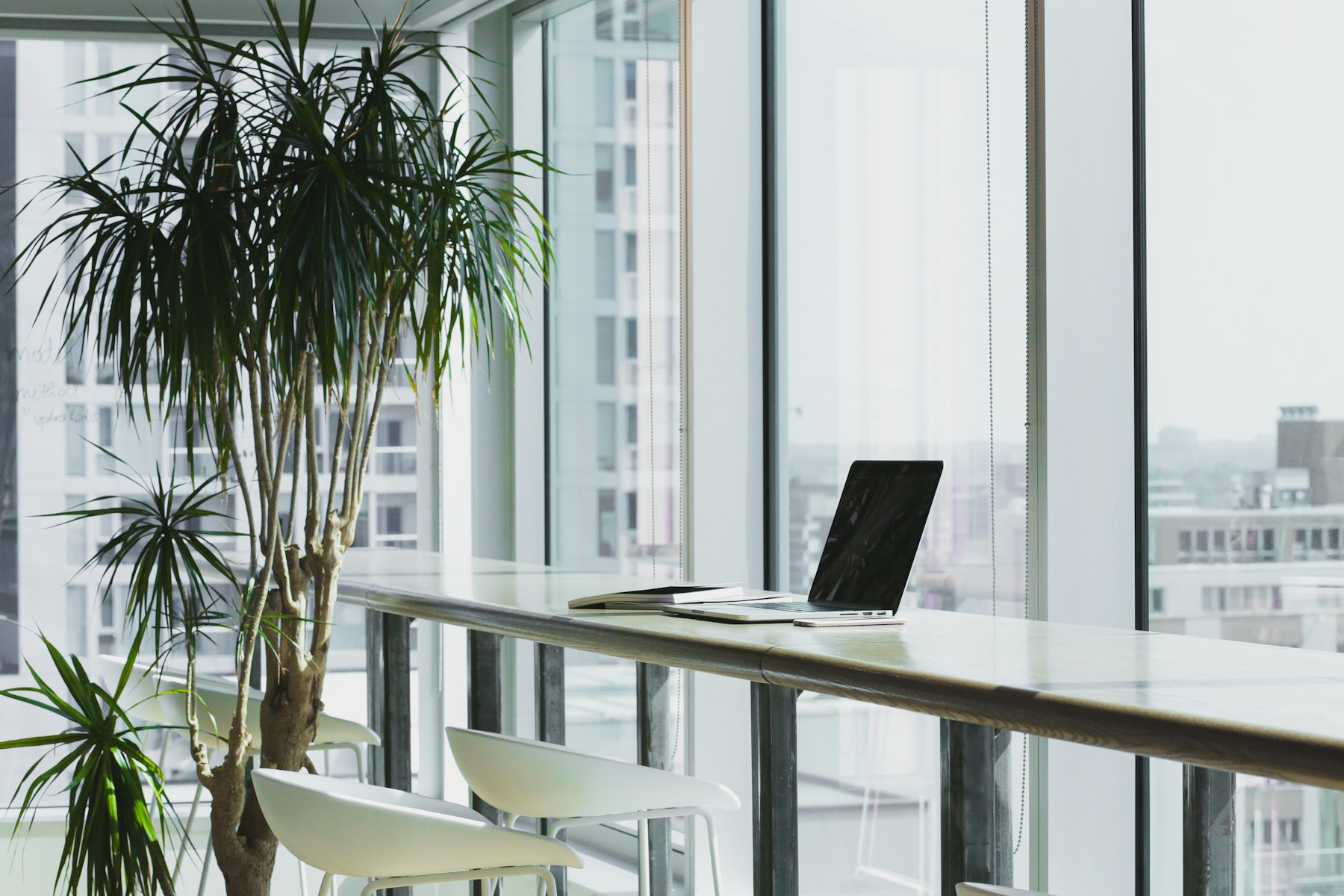 A bright workspace with a laptop by a window