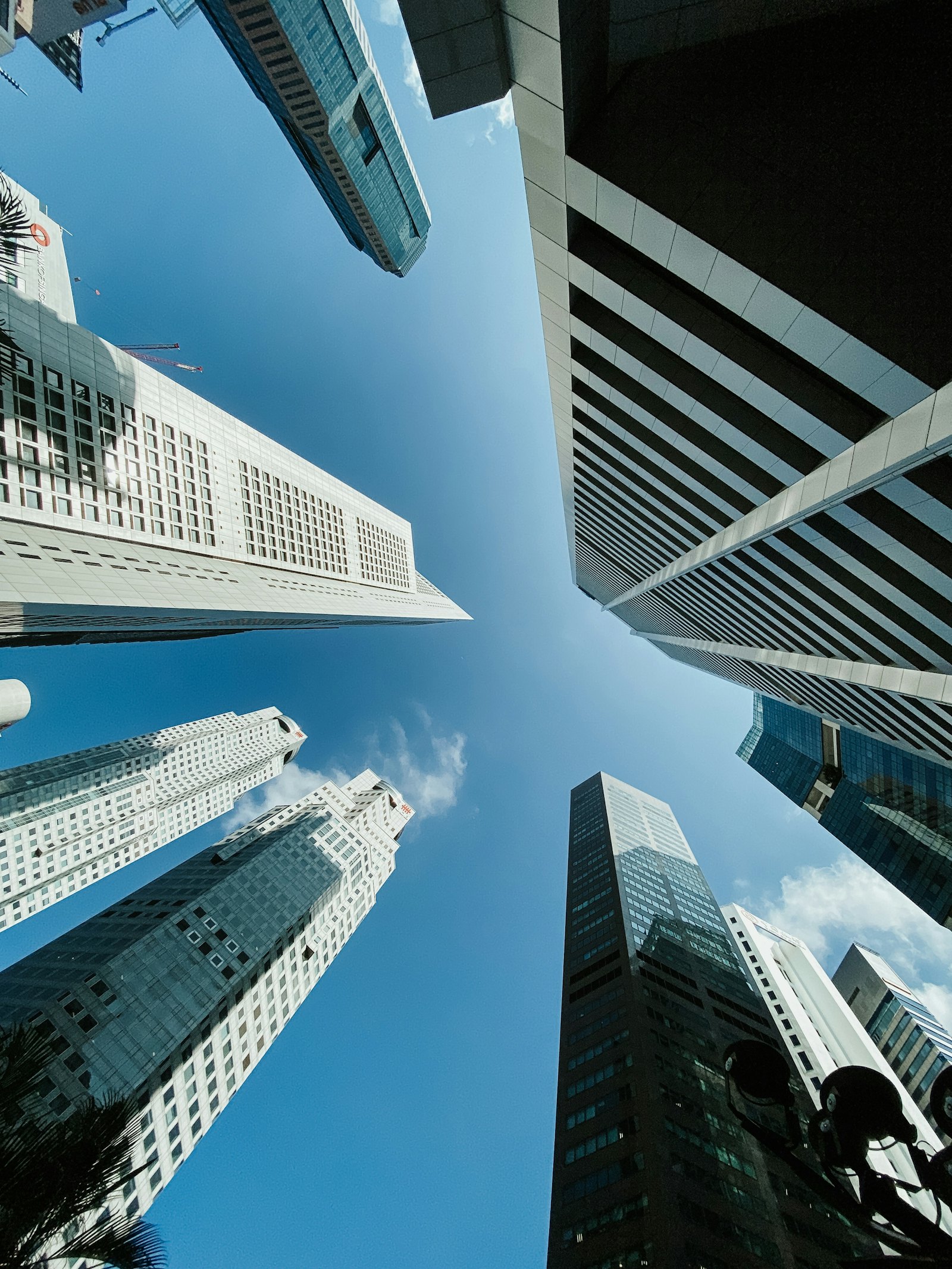 Looking up at office towers against a blue sky in Singapore